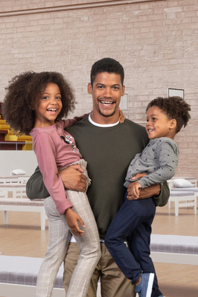 Joyful young father with his happy children in a handshift hospital