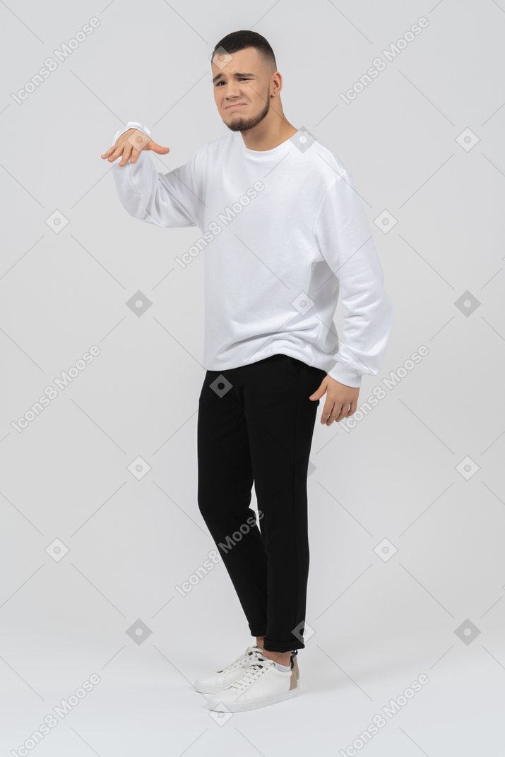 Young man in casual clothes looking unimpressed