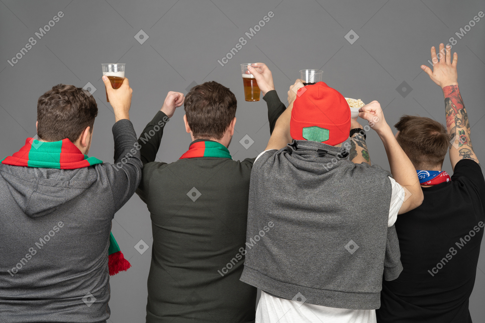 Back view of four male football fans celebrating the victory & holding beer