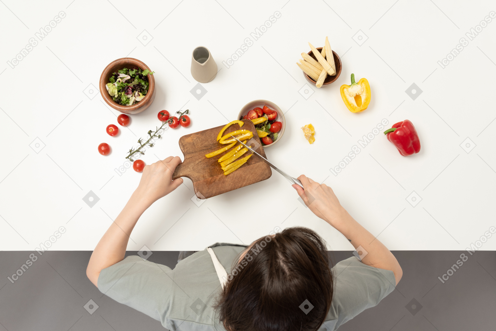 A young woman cutting bell pepper