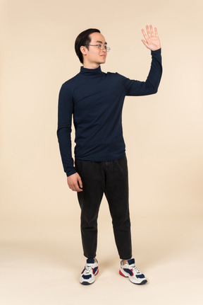 Young asian man waving