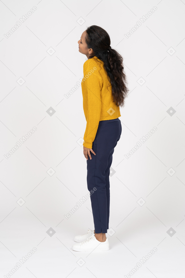 Side view of a girl in casual cltohes looking up