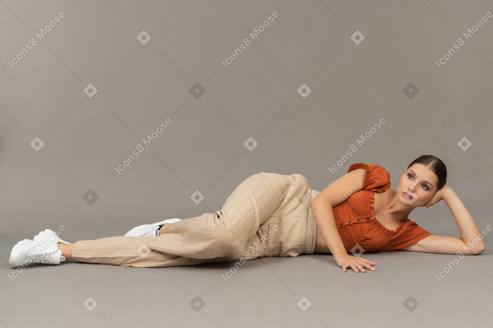 Young woman lying down on floor