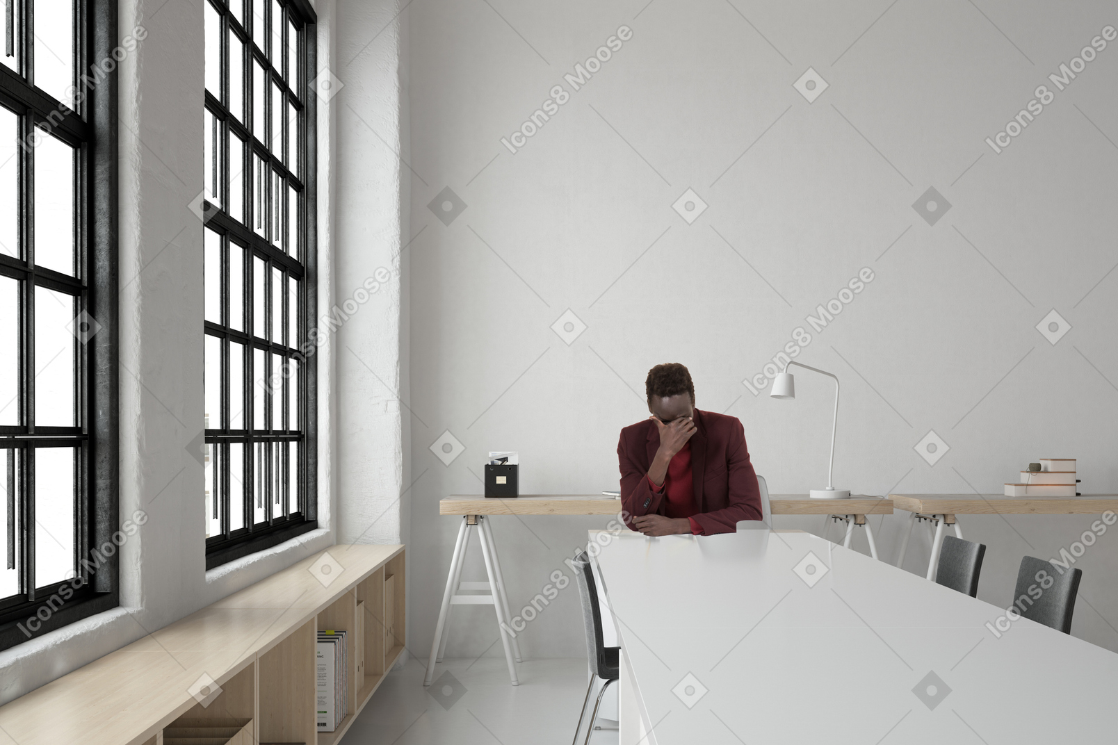 A frustrated man sitting at a table in an office