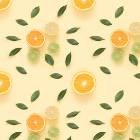 Citrus slices and green leaves over pastel background