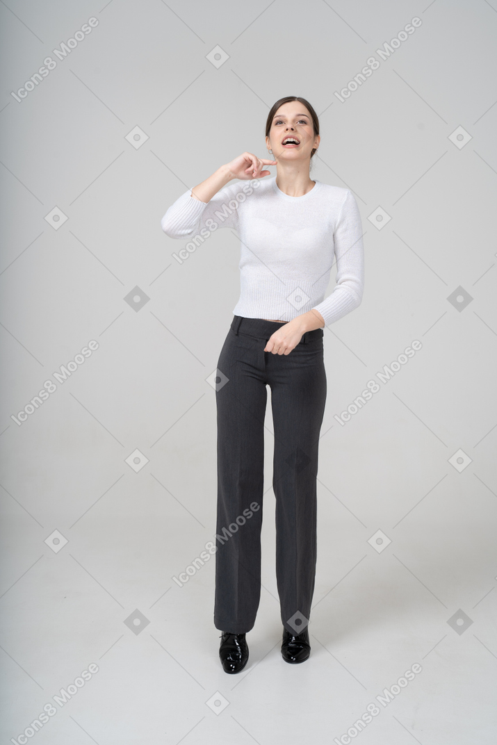 Front view of a happy woman in suit gesturing