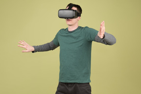 Man in virtual reality headset touching imaginary walls