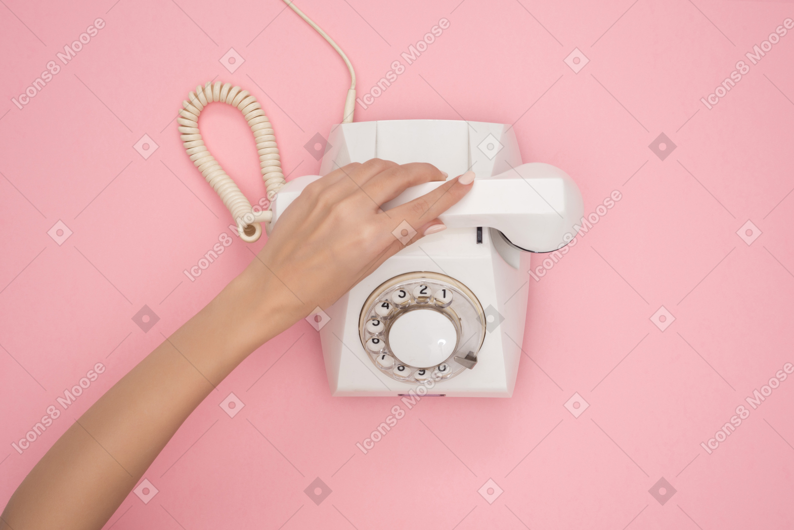 Female hand putting down phone receiver