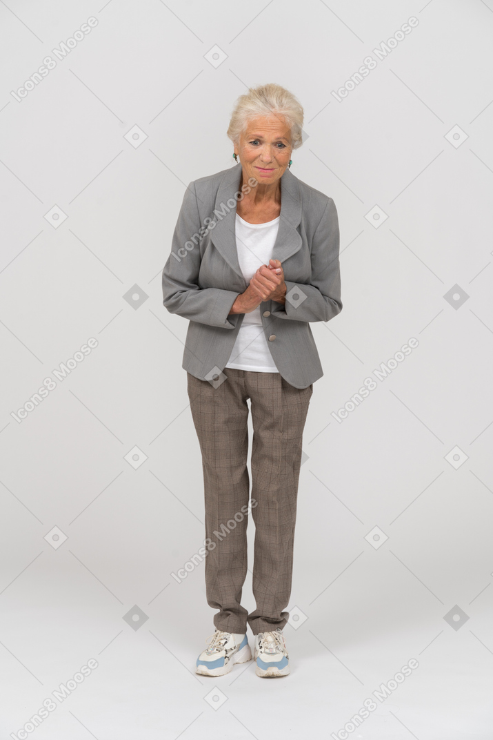 Front view of a happy old lady looking at camera