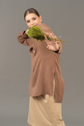 Young woman holds a bouquet of flowers with her hand