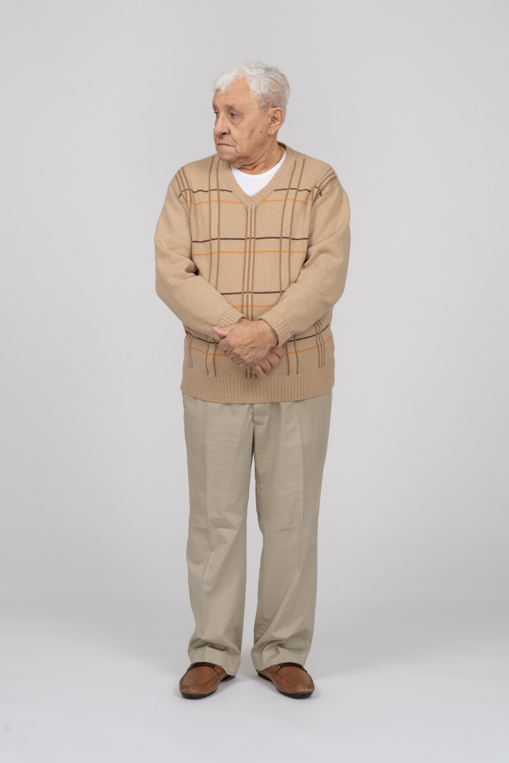 Front View Of An Old Man In Casual Clothes Standing With Crossed Hands 