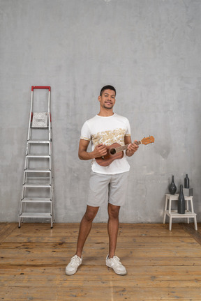 Front view of a man playing ukulele