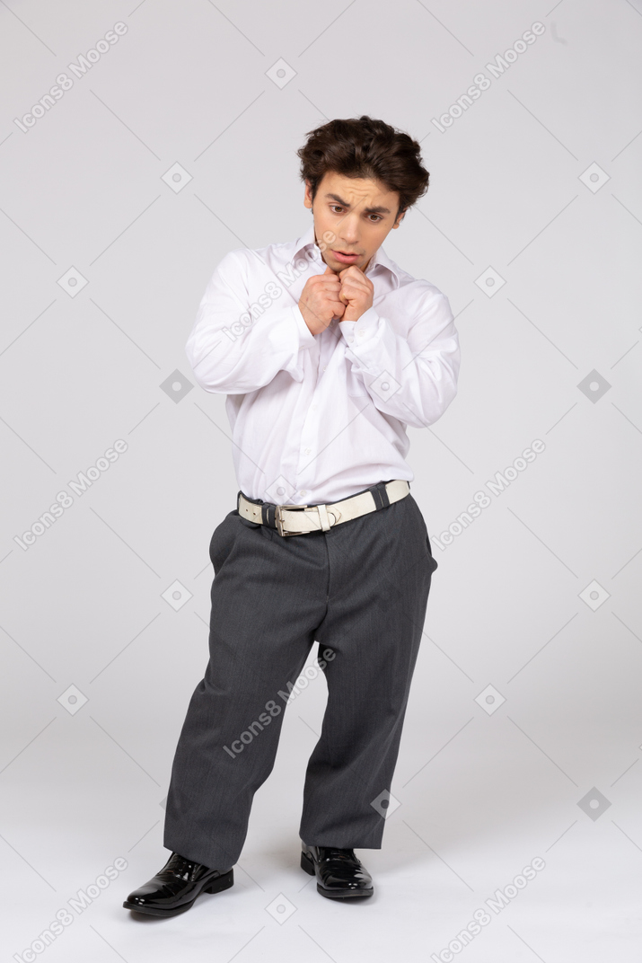 Worrying young man with folded hands