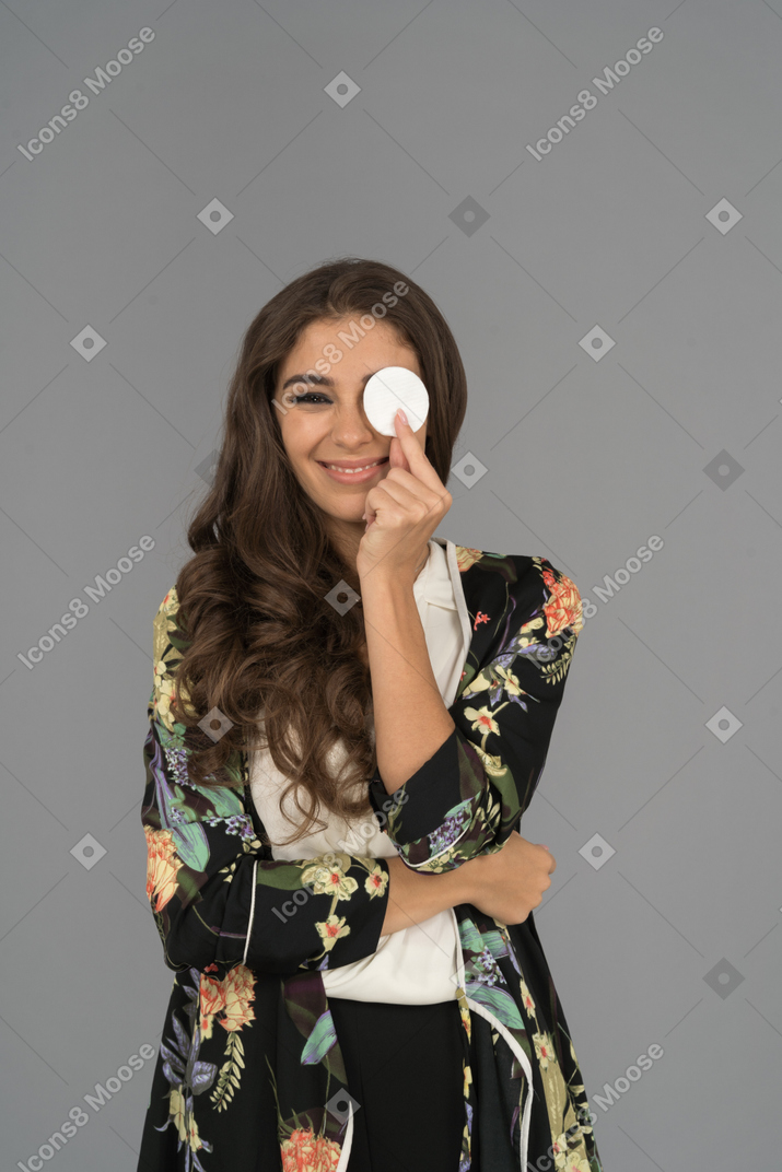 Smiling beautiful lady holding cotton pad