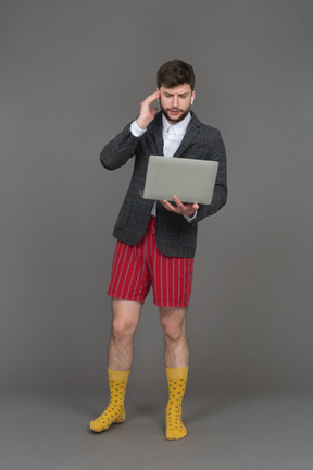 Businessman in red shorts working remotely