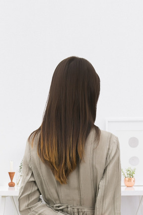The back of a woman standing in front of a table