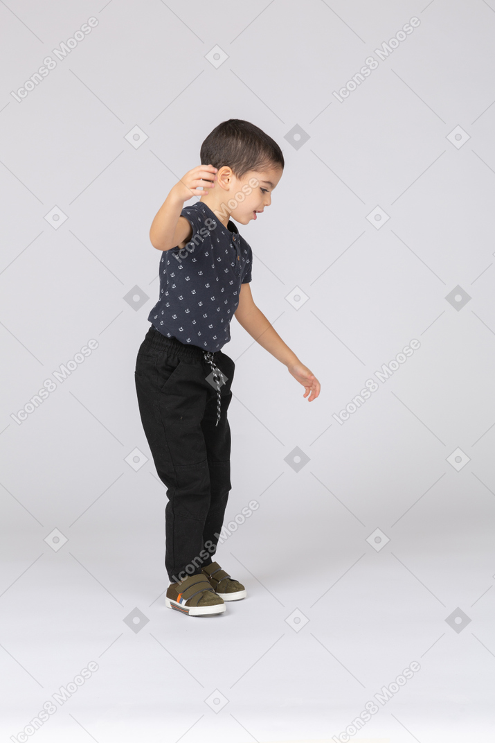 Side view of a cute boy dancing