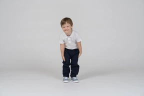 Smiling boy standing and leaning forward