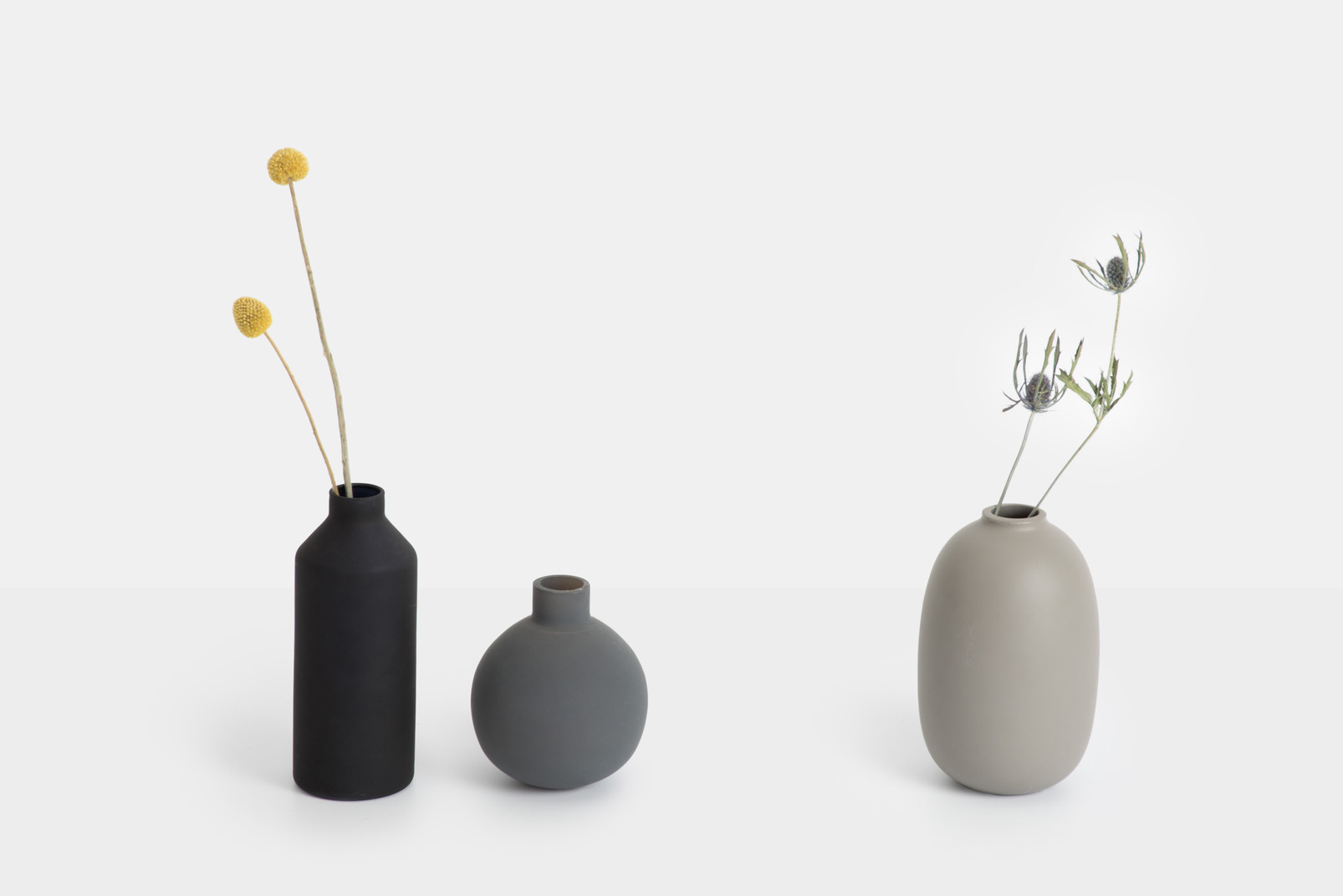 Three ceramic vases with dried flowers