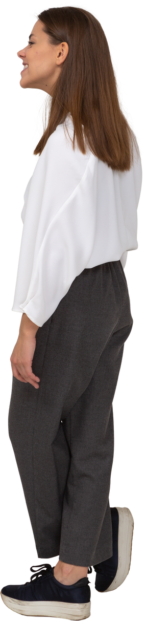 Side view of a young lady in office clothing smiling