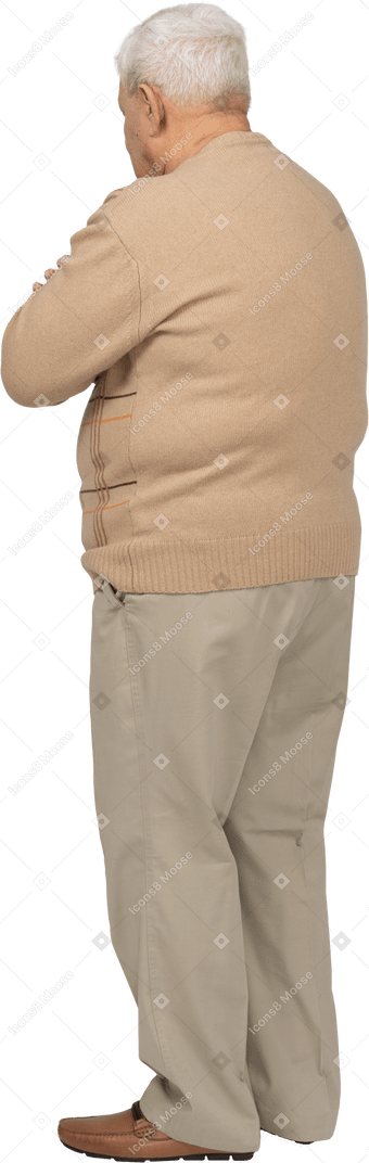 Vista posteriore di un vecchio in abiti casual in piedi con le braccia incrociate