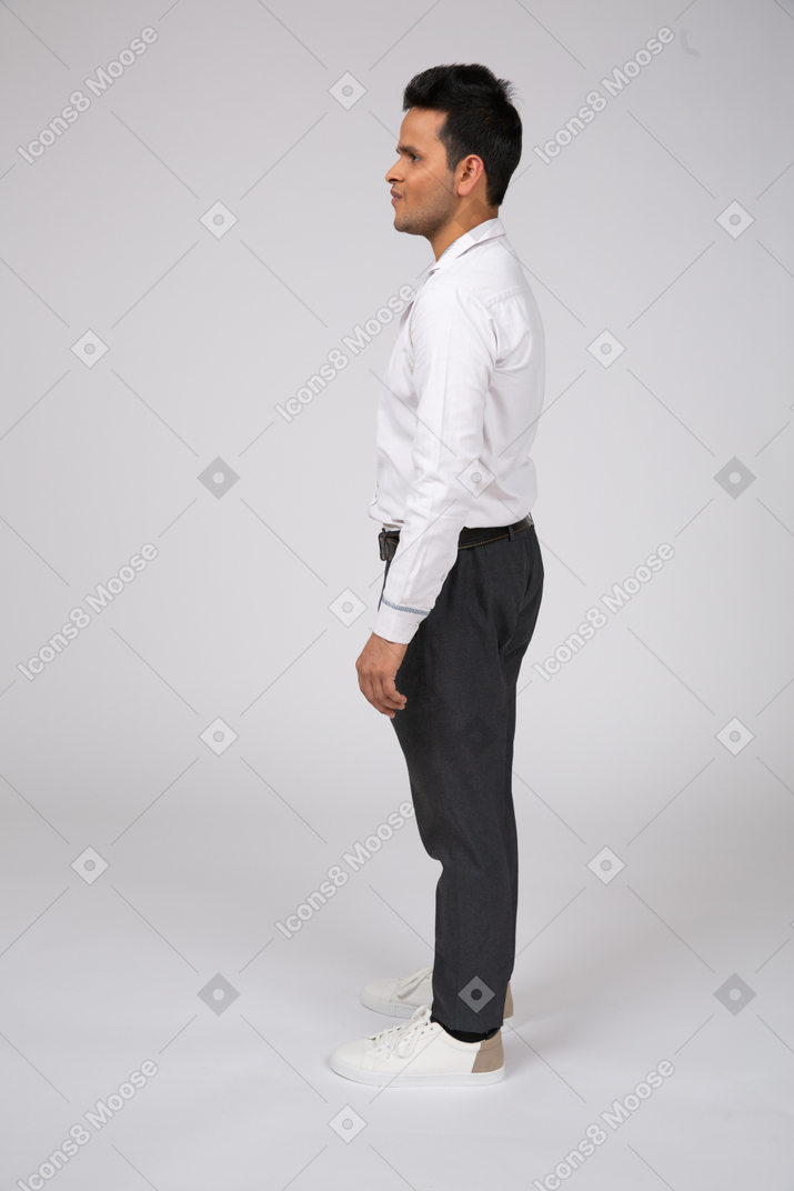 Side view of a man in office clothes standing