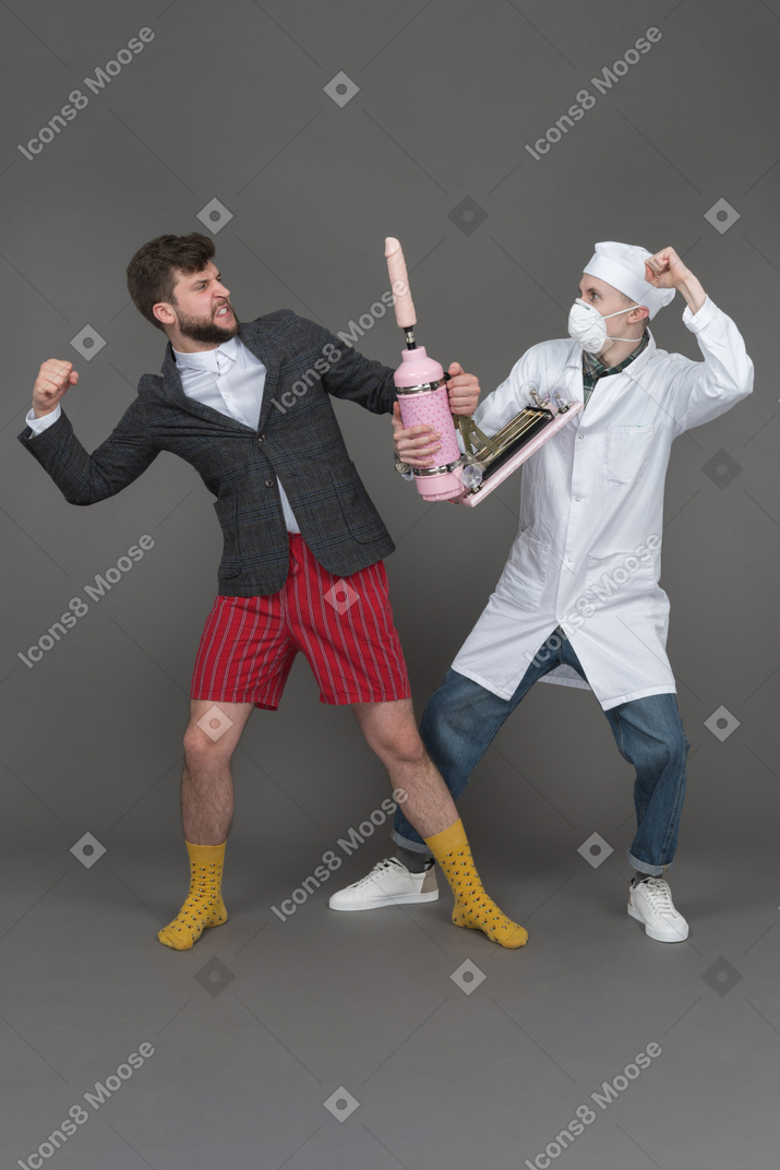 Doctor and young man fighting for sex machine