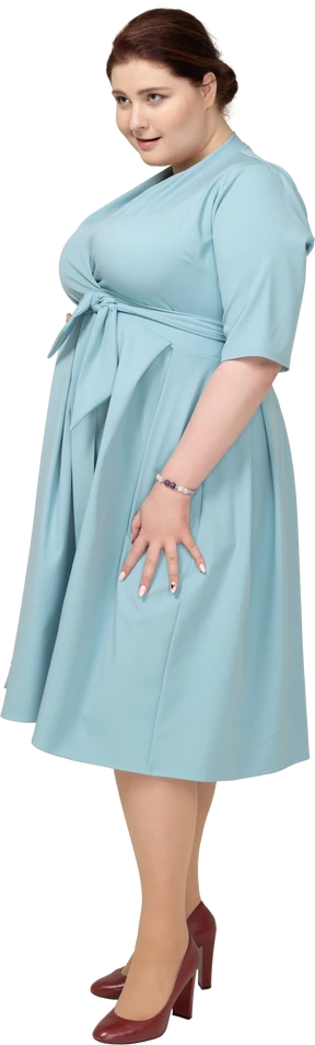Woman in blue dress posing in profile