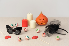 Candles, pumpkins, mask and candy eyeballs