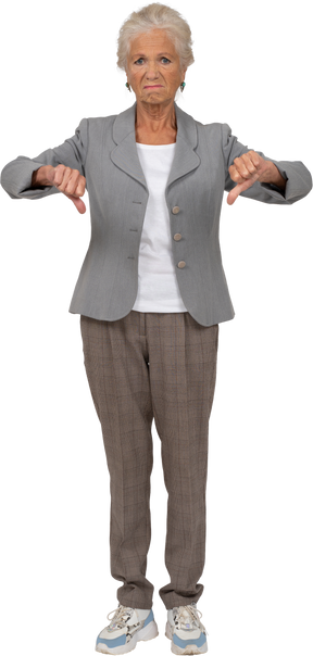 Front view of an old lady in suit showing thumbs down