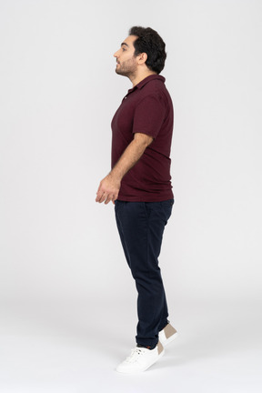 Man in casual clothes standing on tiptoe