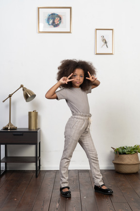 Good looking girl kid posing on the apartment background