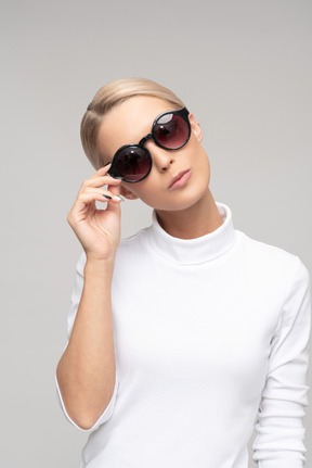 Attractive 'bossy' woman wearing sunglasses