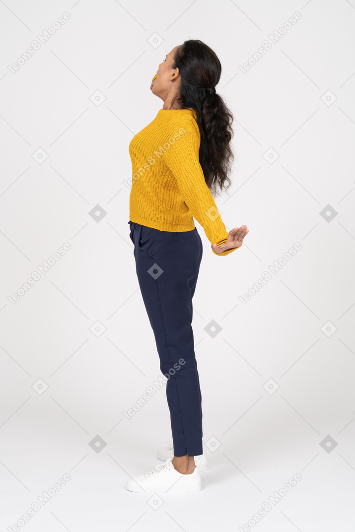 Side view of a girl in casual clothes stretching