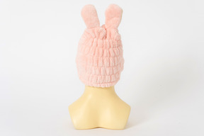 Pink bunny hat on a mannequin head