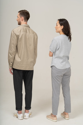 Three-quarter back view of young couple standing