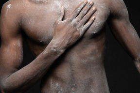 Close-up a male torso all in flour with an arm on it