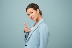 Attractive young woman pointing at you with her index finger