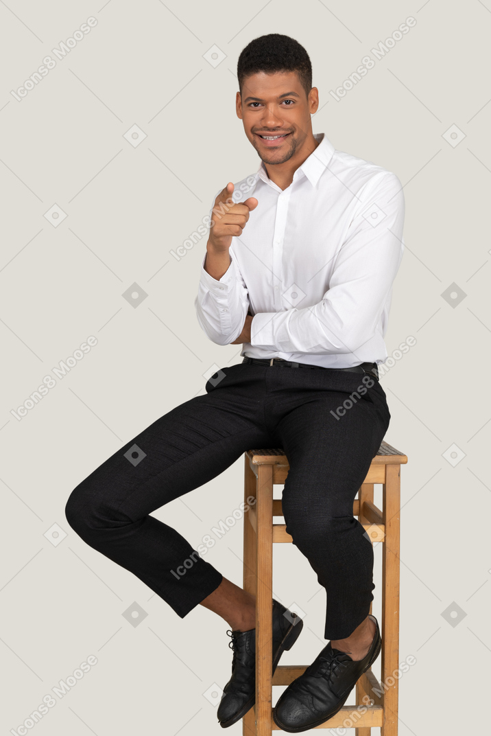 Good looking young man sitting on the chair