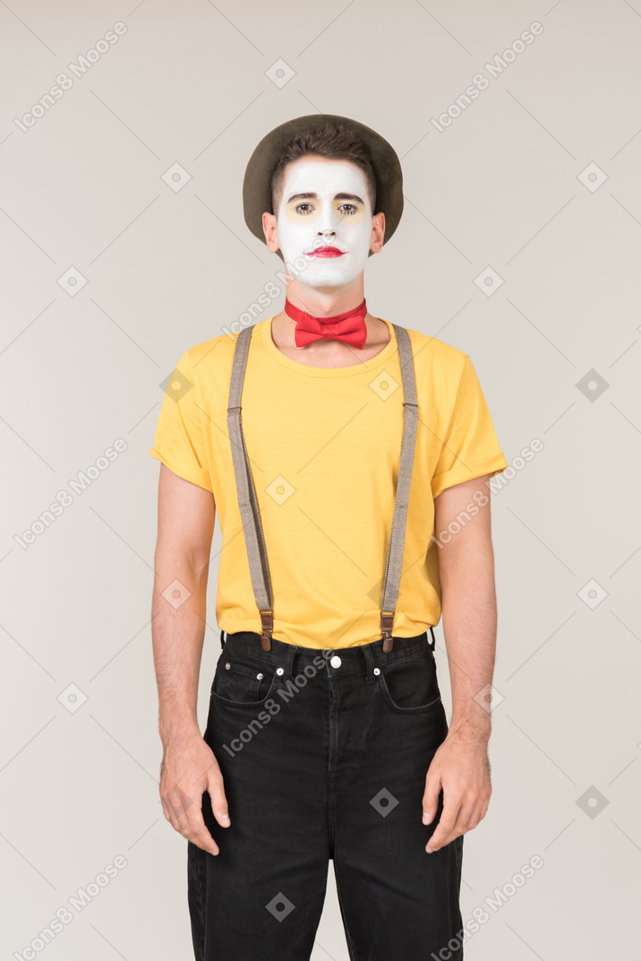 Serious looking male clown looking right to the camera