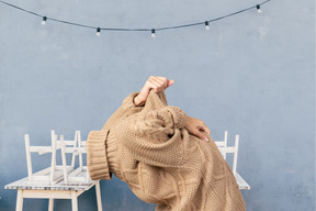 A woman taking off a sweater