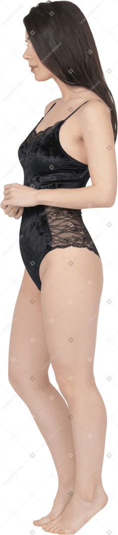 Woman in black bodysuit posing in profile