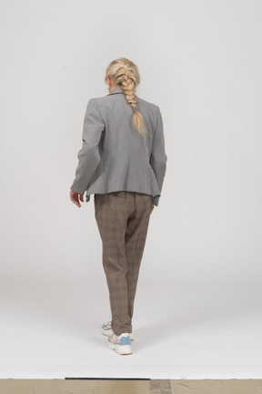 Rear view of an old lady in suit looking down