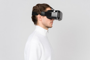 Side view of young man in vr headset