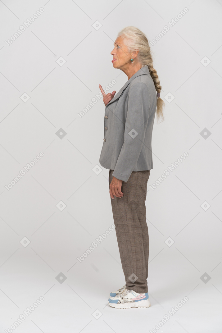 Side view of an old lady in suit gesturing