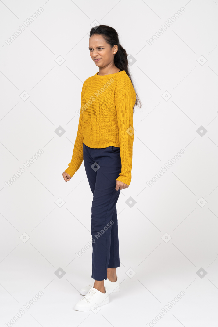 Front view of an angry girl in casual clothes staring at something