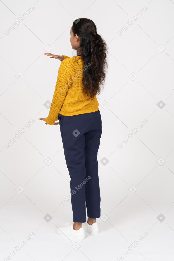 Rear view of a girl in casual clothes showing size of something