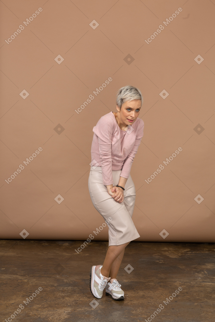 Front view of a woman in casual clothes suffering from pain