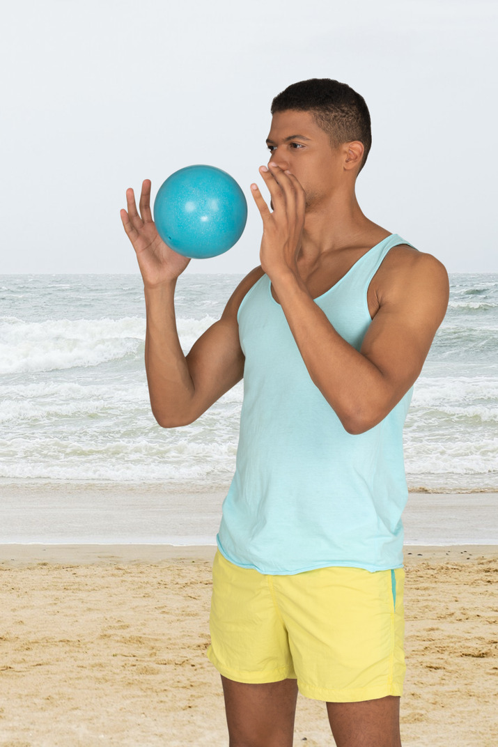 Young men playing with a beach ball