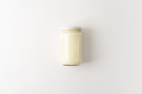 Glass jar with some white sauce